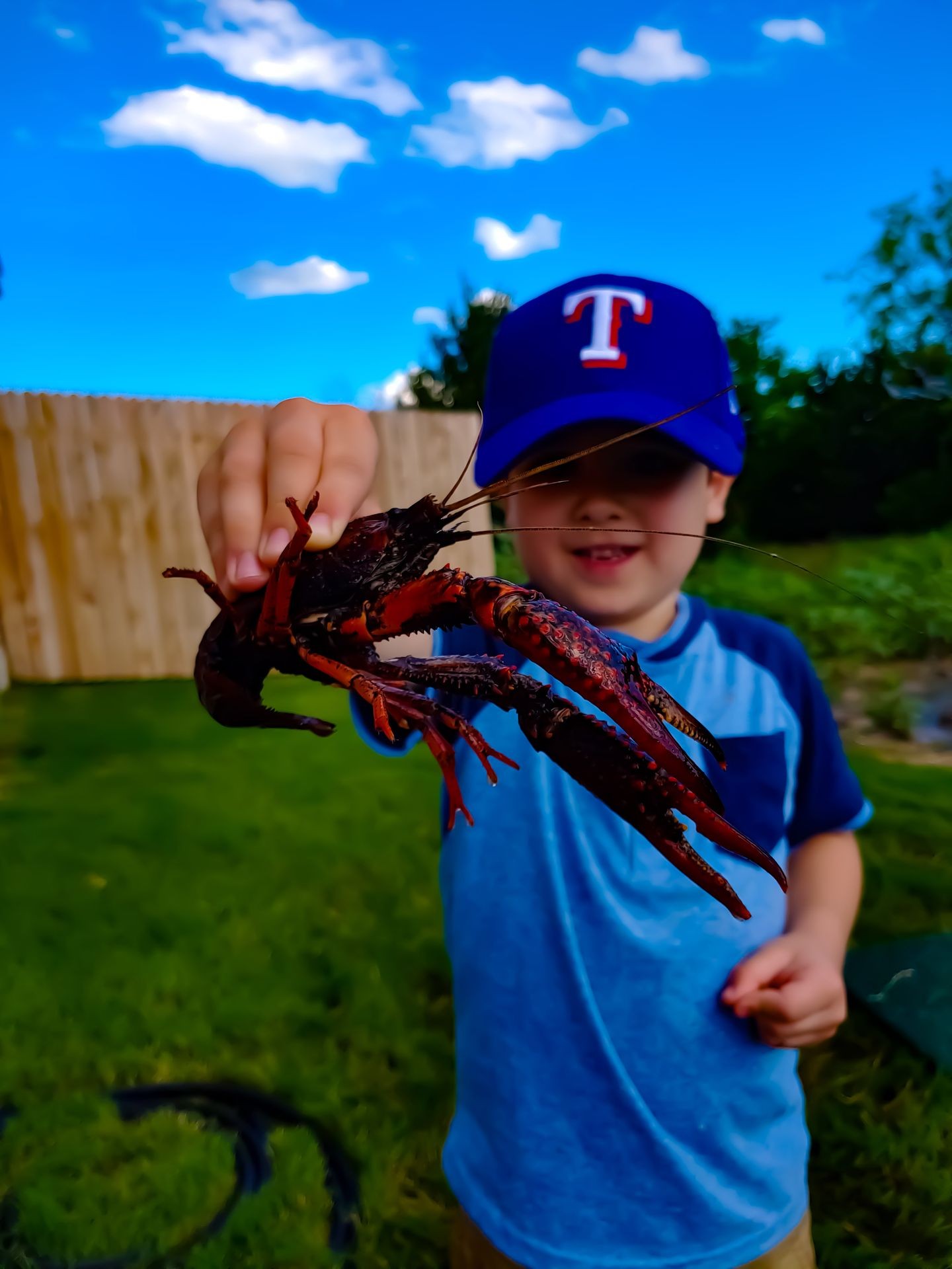 Photo taken by Thomas George of Time Capsule Photography. Blake proudly holding a crawfish at the annual crawfish boil in New Braunfels, TX. A perfect example of capturing summer time get togethers with family and friends. TimeCapsulePhotography.com